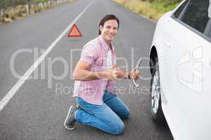 Man changing wheel after a car breakdown