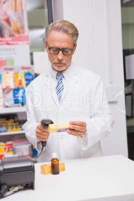 Senior pharmacist using the computer