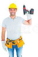 Handyman wearing tool belt while holding power drill