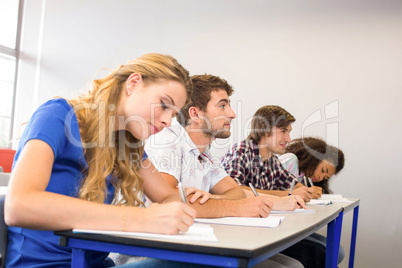 Students writing notes in classroom