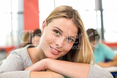 Smiling female student in classroom