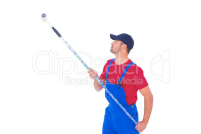 Handyman painting with roller on white background