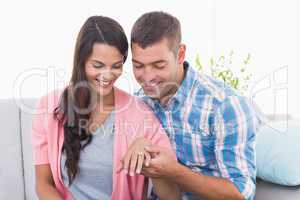 Man looking at womans engagement ring