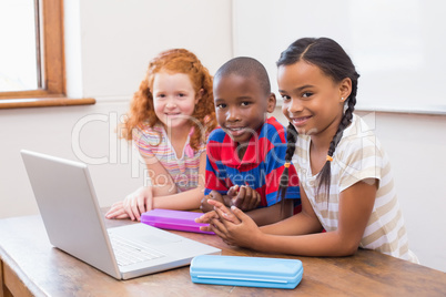 Cute pupils using computer