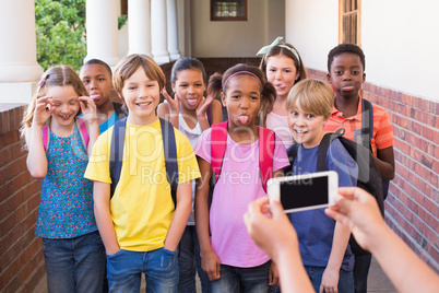 Cute pupils using mobile phone