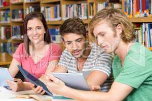 College students using digital tablets in library