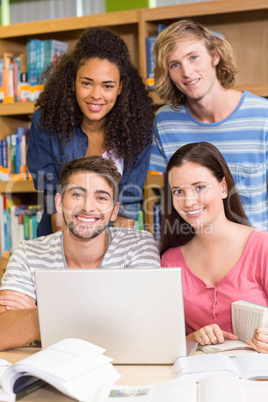 College students using laptop in library