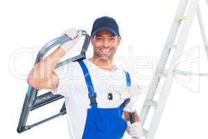 Happy handyman with chair and paint roller on white background