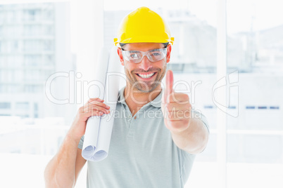Happy handyman with rolled up blueprint gesturing thumbs up