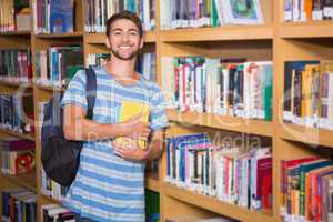 Student smiling at camera in library