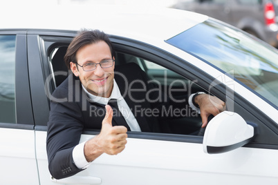 Smiling businessman with thumb up