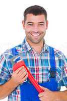 Confident male repairman holding monkey wrench