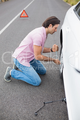 Man changing wheel after a car breakdown