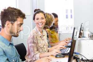 Student smiling at camera in computer class