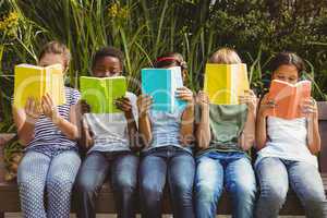 Children reading books at park