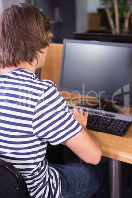 Student using computer in classroom