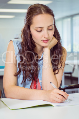 Fashion student taking notes in class