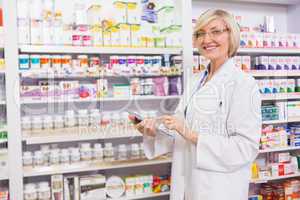 Smiling pharmacist using tablet pc