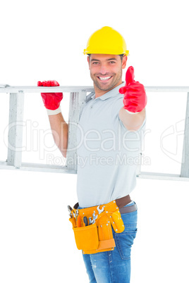 Smiling handyman carrying ladder while gesturing thumbs up