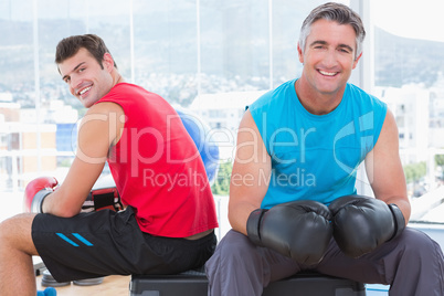 Men with box gloves smiling at camera