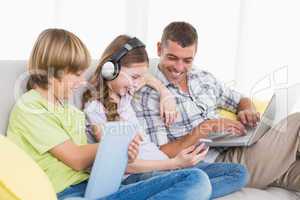 Happy man with children using technologies