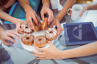 Fashion students eating doughnuts
