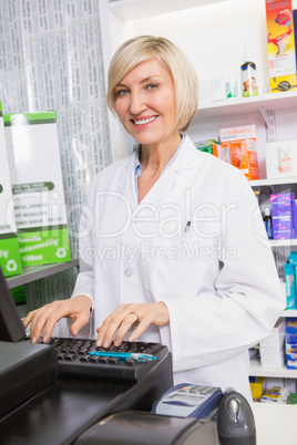 Smiling pharmacist using computer