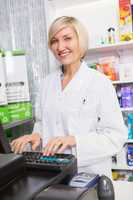 Smiling pharmacist using computer