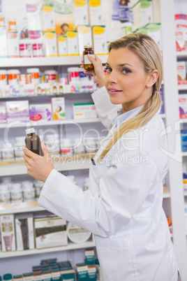 Smiling student taking jar from shelf