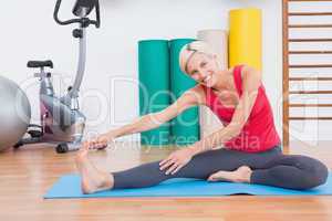 Blonde woman working on exercise mat