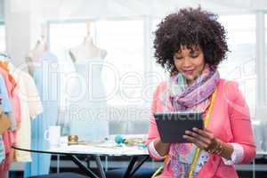 Female fashion designer using digital tablet