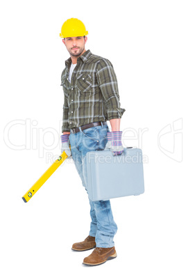 Manual worker with spirit level and toolbox