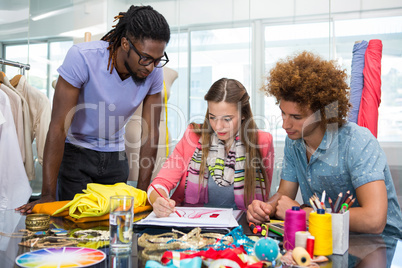 Team of fashion designers sketching Team of fashion designers sketching