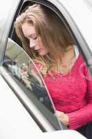 Young woman holding seat belt