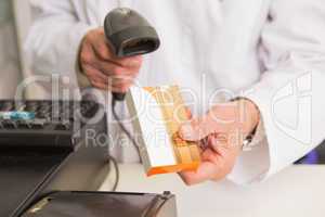 Pharmacist scanning medication with a scanner