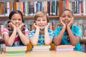 Cute pupils looking at camera in library