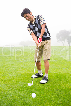 Golfer teeing off