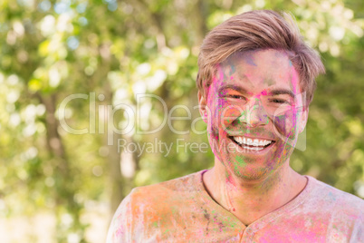 Happy man covered in powder paint