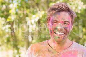 Happy man covered in powder paint