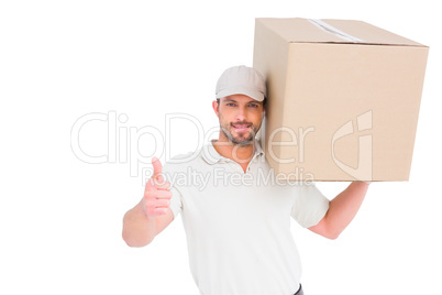 Delivery man with cardboard box gesturing thumbs up