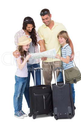 Family with luggage exploring map