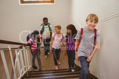School kids walking up stairs in school