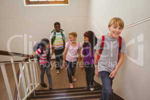 School kids walking up stairs in school