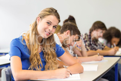 Students writing notes in classroom
