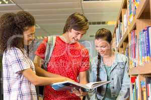 College students reading book in library