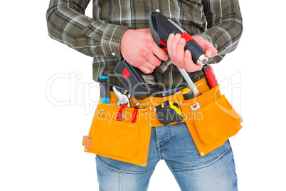 Manual worker holding gloves and hammer power drill