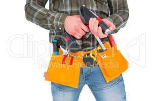 Manual worker holding gloves and hammer power drill