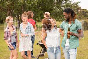 Happy friends in the park having barbecue