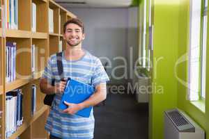 Student smiling at camera in library