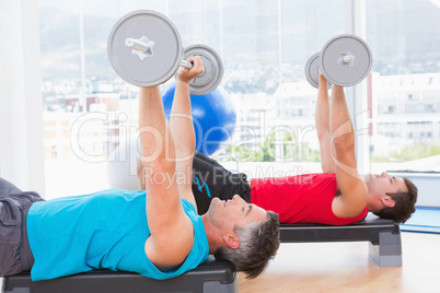 Men lifting barbell